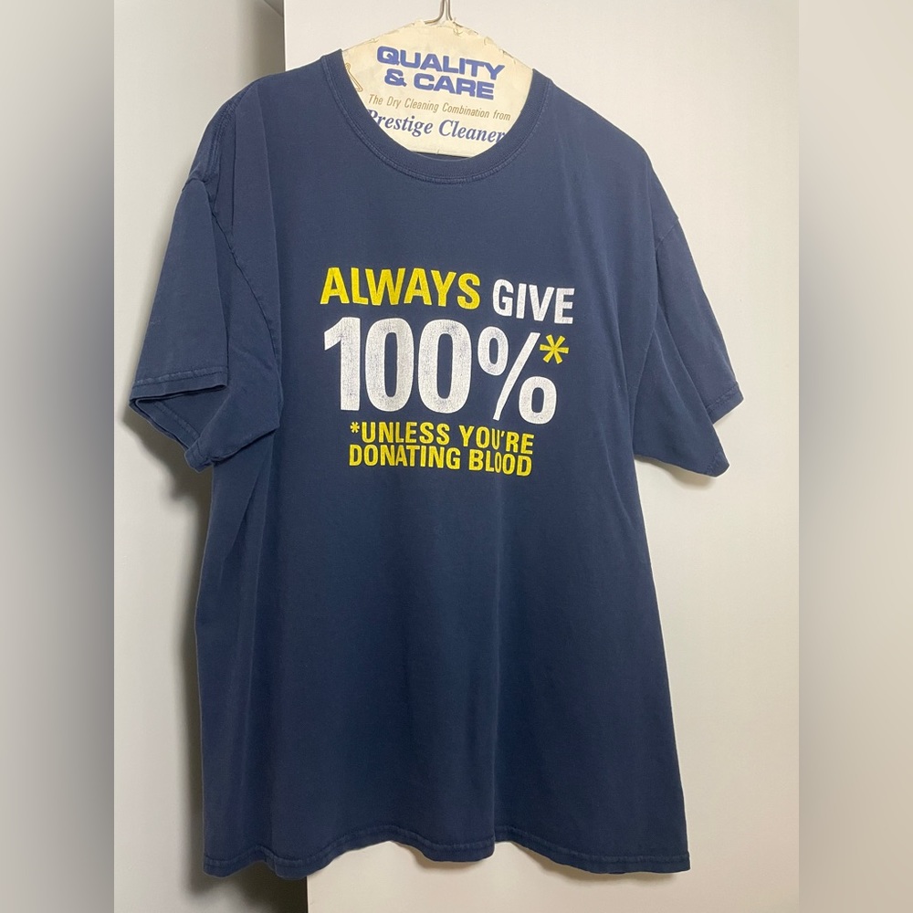 * L blue “Always Give 100%” graphic tee